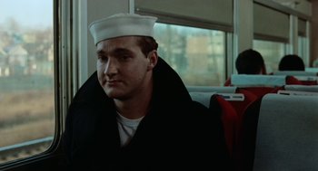 Movie still from “The Last Detail” (1973), directed by Hal Ashby – A man wearing a sailor's hat sitting on a bus; Close Up shot, Low angle