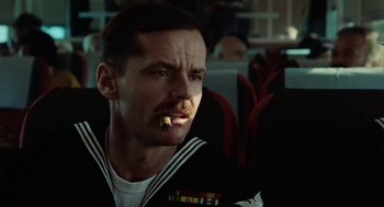 Movie still from “The Last Detail” (1973), directed by Hal Ashby – A man in a navy uniform with a cigarette in his mouth; Close Up shot, Low angle