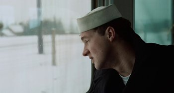 Movie still from “The Last Detail” (1973), directed by Hal Ashby – A man wearing a hat looking out of a window; Close Up shot, Low angle