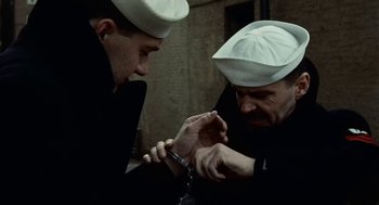 Movie still from “The Last Detail” (1973), directed by Hal Ashby – Two men in white hats are holding a pair of knifes in their hands; Close Up shot, High angle