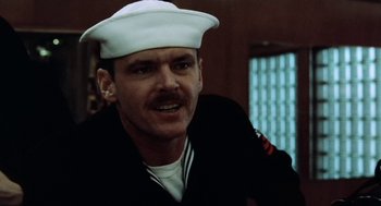 Movie still from “The Last Detail” (1973), directed by Hal Ashby – A man wearing a white hat and a black jacket; Close Up shot, Low angle
