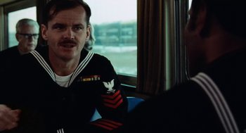 Movie still from “The Last Detail” (1973), directed by Hal Ashby – A man in a uniform sitting next to another man; Close Up shot, Over the shoulder angle