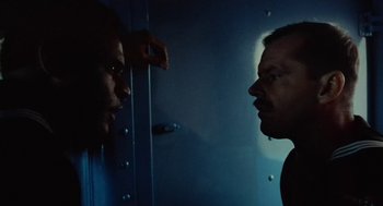 Movie still from “The Last Detail” (1973), directed by Hal Ashby – A man looking at another man in a mirror; Close Up shot, Low angle