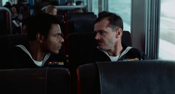 Movie still from “The Last Detail” (1973), directed by Hal Ashby – Two men are sitting on a bus and talking; Medium shot, Over the shoulder angle