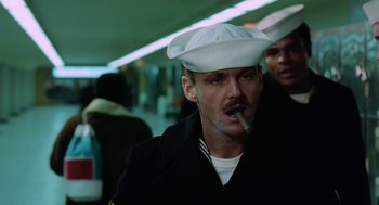 Movie still from “The Last Detail” (1973), directed by Hal Ashby – A man wearing a white hat and smoking a cigarette; Close Up shot, Low angle