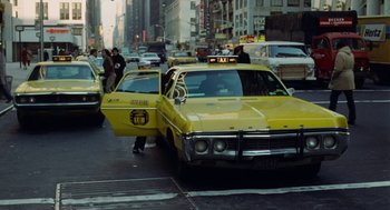 Movie still from “The Last Detail” (1973), directed by Hal Ashby – A yellow taxi cab parked on the side of the street; Wide shot, Low angle