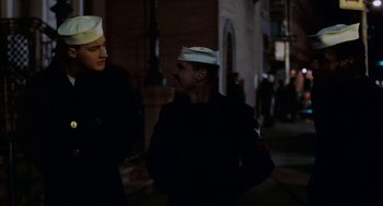 Movie still from “The Last Detail” (1973), directed by Hal Ashby – Two men talking on the sidewalk at night; Medium shot, Over the shoulder angle