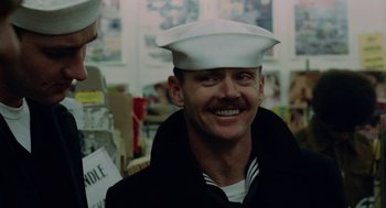 Movie still from “The Last Detail” (1973), directed by Hal Ashby – A man wearing a sailor's hat smiling for the camera; Close Up shot, Low angle