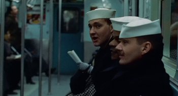 Movie still from “The Last Detail” (1973), directed by Hal Ashby – A group of men in white hats are on a train; Close Up shot, Low angle