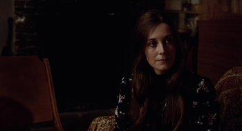 Movie still from “The Last Detail” (1973), directed by Hal Ashby – A woman sitting on a couch in a dark room; Close Up shot, High angle