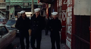 Movie still from “The Last Detail” (1973), directed by Hal Ashby – A group of men walking down a street; Wide shot, High angle
