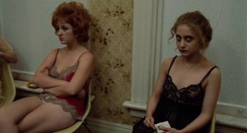 Movie still from “The Last Detail” (1973), directed by Hal Ashby – Two young women sitting in a room , one of which is holding a nintendo wii game controller; Medium shot, High angle