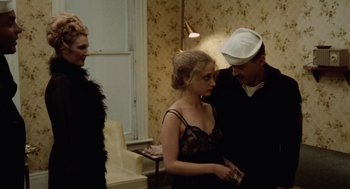 Movie still from “The Last Detail” (1973), directed by Hal Ashby – A group of people standing next to each other in a room; Medium shot, Over the shoulder angle