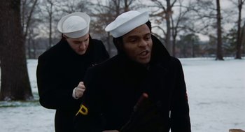 Movie still from “The Last Detail” (1973), directed by Hal Ashby – Two people in black jackets and white hats; Medium shot, Low angle
