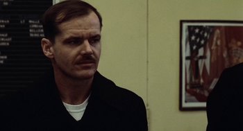 Movie still from “The Last Detail” (1973), directed by Hal Ashby – A person wearing a black jacket; Close Up shot, Over the shoulder angle