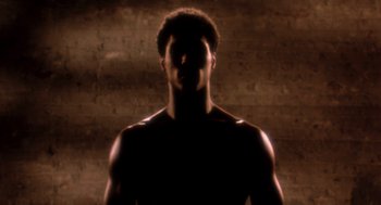 Movie still from “The Last Dragon” (1985), directed by Michael Schultz – A man with his eyes closed in front of a brick wall; Close Up shot, Low angle