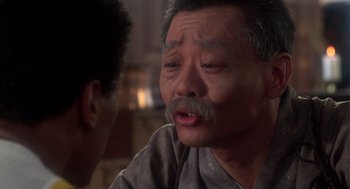 Movie still from “The Last Dragon” (1985), directed by Michael Schultz – An older man with a mustache is talking to a younger man; Close Up shot, Over the shoulder angle