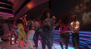 Movie still from “The Last Dragon” (1985), directed by Michael Schultz – A group of people dancing and singing in a nightclub; Wide shot, Over the shoulder angle