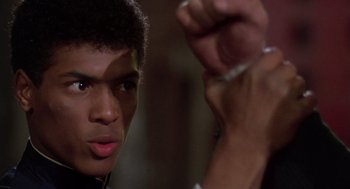 Movie still from “The Last Dragon” (1985), directed by Michael Schultz – A young man is holding something in his hand; Close Up shot, Low angle