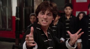 Movie still from “The Last Dragon” (1985), directed by Michael Schultz – A young man in a black shirt is pointing at the camera; Close Up shot, Low angle