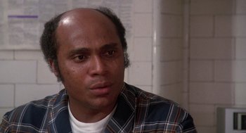 Movie still from “The Last Dragon” (1985), directed by Michael Schultz – A person wearing a plaid shirt; Close Up shot, Low angle