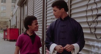 Movie still from “The Last Dragon” (1985), directed by Michael Schultz – Two young men standing next to each other outside; Medium shot, Low angle
