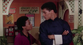 Movie still from “The Last Dragon” (1985), directed by Michael Schultz – Two young men are talking in a restaurant; Medium shot, Over the shoulder angle