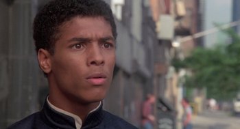 Movie still from “The Last Dragon” (1985), directed by Michael Schultz – A young man is standing in the middle of the street; Close Up shot, Low angle
