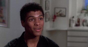 Movie still from “The Last Dragon” (1985), directed by Michael Schultz – A young man in a black shirt is looking at the camera; Close Up shot, Low angle