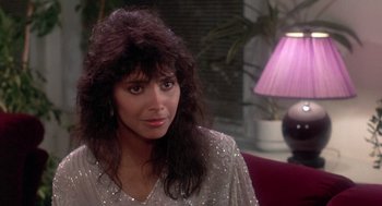 Movie still from “The Last Dragon” (1985), directed by Michael Schultz – A person sitting in a room; Close Up shot, Over the shoulder angle