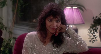 Movie still from “The Last Dragon” (1985), directed by Michael Schultz – A woman in a sequined top posing for a picture; Close Up shot, Low angle