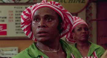 Movie still from “The Last Dragon” (1985), directed by Michael Schultz – A man wearing a red and white striped hat; Close Up shot, Low angle