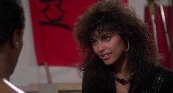 Movie still from “The Last Dragon” (1985), directed by Michael Schultz – A person wearing a black jacket; Close Up shot, Over the shoulder angle