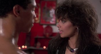 Movie still from “The Last Dragon” (1985), directed by Michael Schultz – A man and a woman talking to each other; Close Up shot, Over the shoulder angle