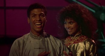 Movie still from “The Last Dragon” (1985), directed by Michael Schultz – A man and a woman standing next to each other; Medium shot, Low angle