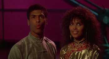 Movie still from “The Last Dragon” (1985), directed by Michael Schultz – A man and a woman standing next to each other; Close Up shot, Low angle