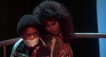 Movie still from “The Last Dragon” (1985), directed by Michael Schultz – A man and a woman with long black hair; Close Up shot, Over the shoulder angle