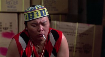Movie still from “The Last Dragon” (1985), directed by Michael Schultz – A man with a hat on and a cigarette in his mouth; Close Up shot, Over the shoulder angle