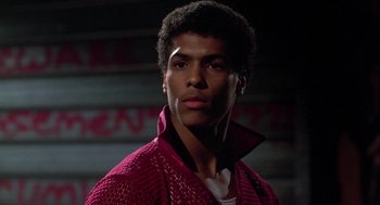 Movie still from “The Last Dragon” (1985), directed by Michael Schultz – A young man in a red jacket is looking at the camera; Close Up shot, Low angle