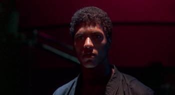 Movie still from “The Last Dragon” (1985), directed by Michael Schultz – A young man is looking into the camera; Close Up shot, Low angle