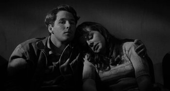 Movie still from “The Last Picture Show” (1971), directed by Peter Bogdanovich – A man and a woman sleeping on a couch; Close Up shot, High angle