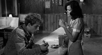 Movie still from “The Last Picture Show” (1971), directed by Peter Bogdanovich – A man and a woman sitting at a table; Medium shot, Over the shoulder angle