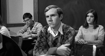 Movie still from “The Last Picture Show” (1971), directed by Peter Bogdanovich – A black and white photo of a young man in a classroom; Close Up shot, Over the shoulder angle