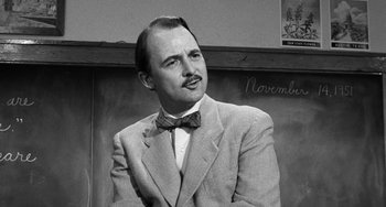 Movie still from “The Last Picture Show” (1971), directed by Peter Bogdanovich – A man wearing a suit and bow tie; Close Up shot, Low angle