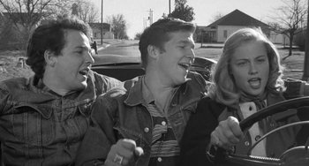 Movie still from “The Last Picture Show” (1971), directed by Peter Bogdanovich – A group of young people standing next to each other; Medium shot, High angle