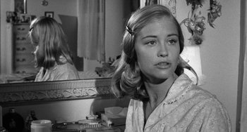 Movie still from “The Last Picture Show” (1971), directed by Peter Bogdanovich – A young woman in front of a bathroom mirror; Close Up shot, Over the shoulder angle