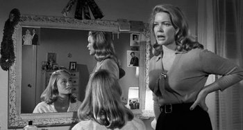 Movie still from “The Last Picture Show” (1971), directed by Peter Bogdanovich – A group of women in front of a large mirror; Medium shot, Over the shoulder angle