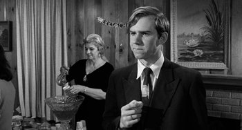 Movie still from “The Last Picture Show” (1971), directed by Peter Bogdanovich – A man and a woman standing next to each other in a room; Medium shot, Over the shoulder angle