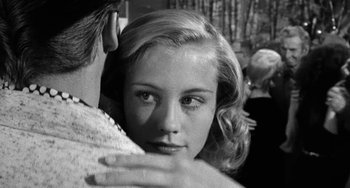 Movie still from “The Last Picture Show” (1971), directed by Peter Bogdanovich – A black - and - white photo of a woman hugging a man; Close Up shot, Over the shoulder angle
