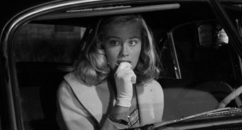 Movie still from “The Last Picture Show” (1971), directed by Peter Bogdanovich – A black and white photo of a woman sitting in the back of a car; Close Up shot, Over the shoulder angle